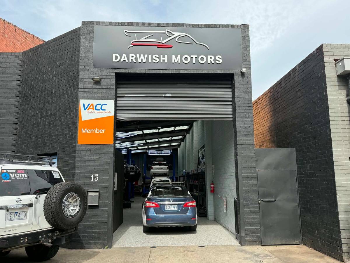 The Darwish Motors shopfront at 13 Hope Street, Brunswick: roller door open onto the workshop, with the VACC Member sign by the entrance